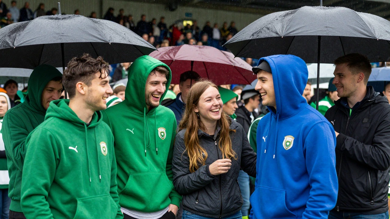 Fans wearing colorful hoodies at rainy GAA match